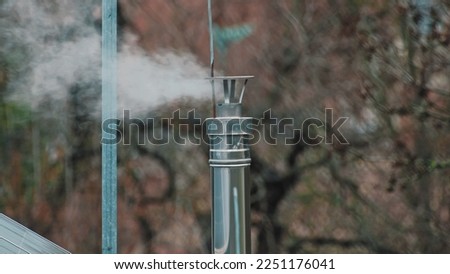 White Smoke Coming Out of Shiny Metal Chimney on Building Room
