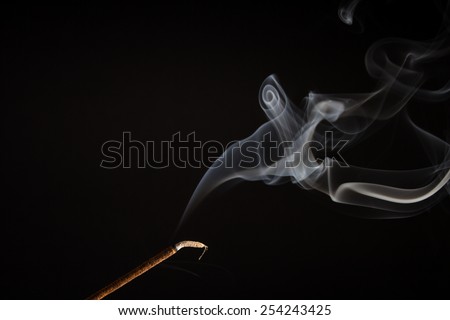 White smoke curling off an incense