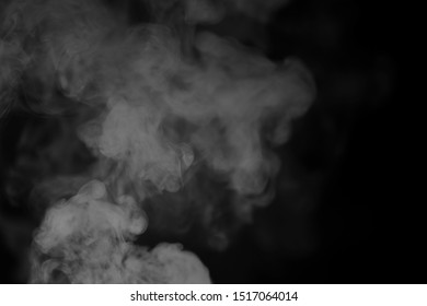 White Smoke On A Black Background. Texture Of Smoke. Clubs Of White Smoke On A Dark Background For Overlay
