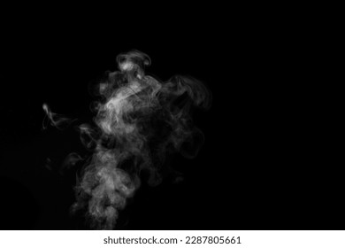 White smoke on black background. Monochrome, grayscale photography of illuminated incense. Moody feeling. Dark backdrop, graphic resource for montage, overlay or texture, copy space.