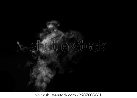 White smoke on black background. Monochrome, grayscale photography of illuminated incense. Moody feeling. Dark backdrop, graphic resource for montage, overlay or texture, copy space.