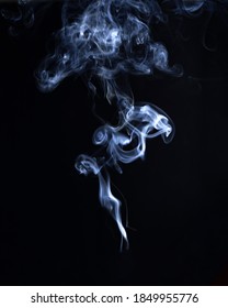 White Smoke Plume Isolated On Black Background. Ornate Ball Of Smoke For Design