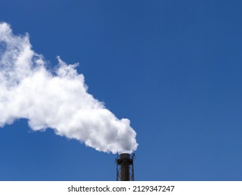 White Smoke Rising From The Factory Chimney