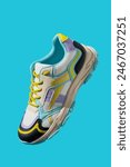 White sneaker with colored accents on blue background, Fashionable sport shoe with colorful backdrop. Studio shot of shoes for shop advertisement, creative minimalist style