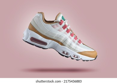White sneaker and colored accents pink gradient background  fashion  sport shoe   air  sneakers  lifestyle  concept  product photo   levitation concept  street wear  trainer