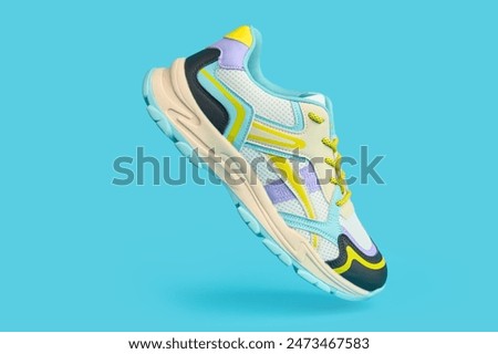 White sneaker with colored accents on blue background, Fashionable sport shoe with colorful backdrop. Studio shot of shoes for shop advertisement, creative minimalist style