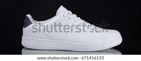 White Sneaker on Black Background, Isolated Product, top view, Studio.