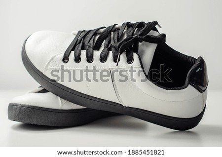 White sneakers with black laces, classic sports shoes, casual style