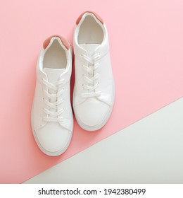 White sneakers, female white leather shoes with laces on pink background. Pair of stylish sneakers Comfortable sportswear hipster womens shoes. Top view square. - Shutterstock ID 1942380499