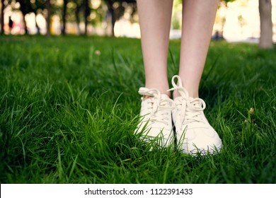    white sneakers in green grass fashion                             - Shutterstock ID 1122391433