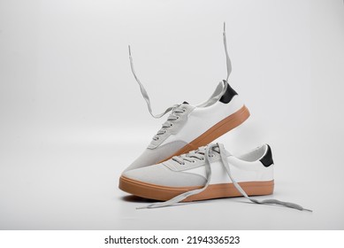 White Sneakers On White Background. Banner With Copy Space. Comfortable Sports Shoes. Unisex Casual Style. A Pair Of Classic Sneakers. All-season Leather Shoe Trend. Sneaker With White Laces. Footwear
