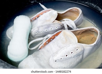 White sneakers in a wash basin soak with washing powder,Cleaning the shoes. 