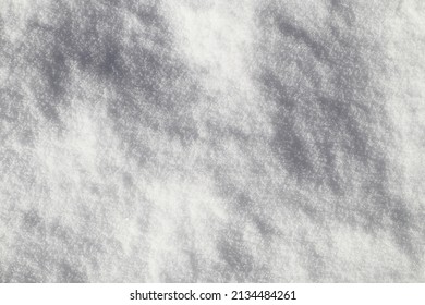 White snow with some tiny shadows. Close up and isolated.