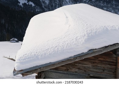 white snowdrift on the slope of a wooden roof, beautiful white landscape, danger of snow falling from the roofs, large snowdrifts on the side, Healthy Lifestyle Concept, Winter Activity
