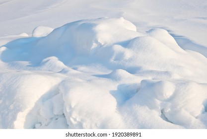white snowdrifts in cold and sunny winter day