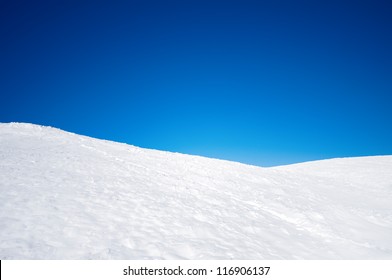 White snowy fields under a blue sky - Powered by Shutterstock