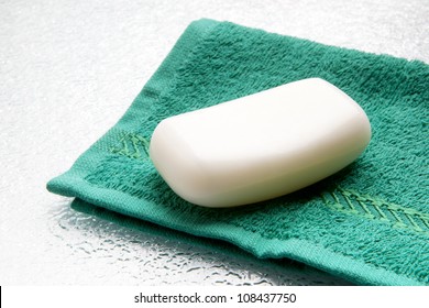 White Soap Bar On Double Towel