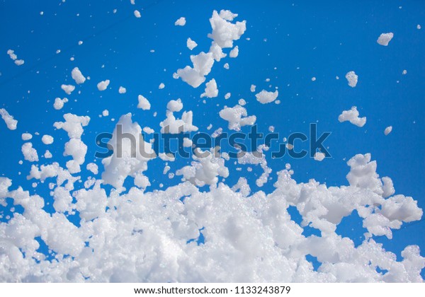 White\
soap foam on a blue sky background. Fun foam, background or texture\
of a white foam with copy space Entertainment foamy parties a\
summer entertainment festival in the water\
park
