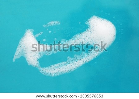 White soap suds isolated on blue background