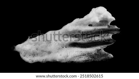 White soapy foam texture. Shampoo foam with bubbles.White facial foam creamy bubble soap sponge isolated on black background.