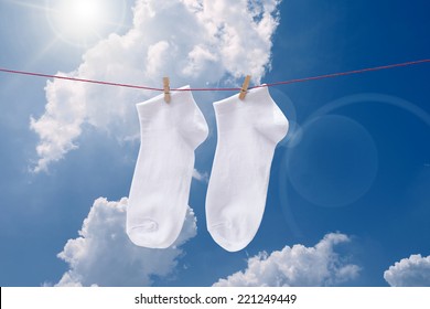 White Socks Hanging  At Blue  Sky 