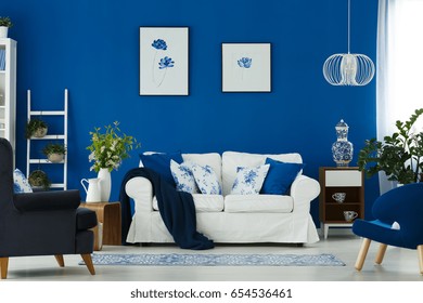 White Sofa And Blue Armchairs In Cozy Living Room