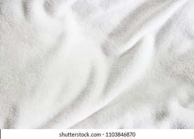 White Soft Wrinkle Fleece Synthetic Cloth Blanket Texture For Background, Wallpaper, Or Backdrop With Space For Text.