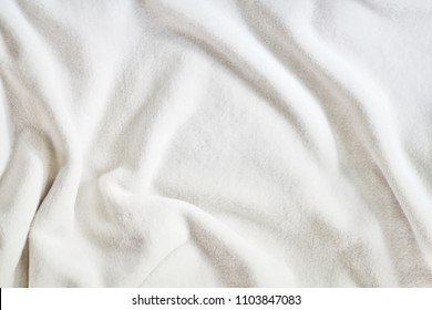 White Soft Wrinkle Fleece Synthetic Cloth Blanket Texture For Background, Wallpaper, Or Backdrop With Space For Text.