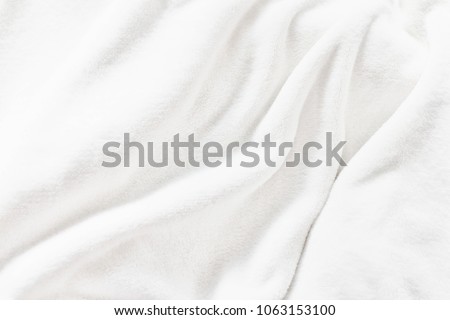White soft wrinkle fleece synthetic cloth blanket texture background, wallpaper, backdrop. Space for text.