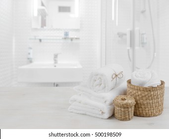 White Spa Towels And Wicker Baskets On Defocused Bathroom Interior