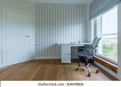 White Spacious Study Room With Wooden Parquet And Stripes On The Wall