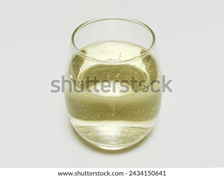 White sparkling wine in a round glass