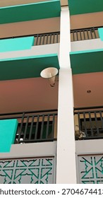 White speaker in the corner of an elementary school.