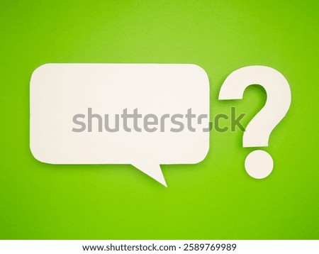 White speech bubble and question mark cutout on a vibrant green background, representing conversation, inquiry, communication, and curiosity. Space for text or message.