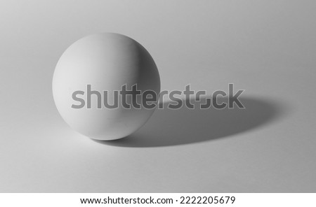 white sphere on white background. Plaster ball with shadow for academic drawing.