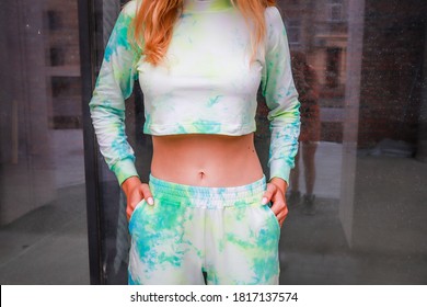 White sport suit with tie dye print.Jogers Girl with blonde hair