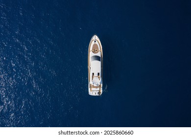 White Sport Yacht Open Sea Aerial View. Super Yacht On Blue Water Top View. Huge White Super Mega Yacht On Blue Water In Italy.