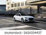 white Sports car speeding on street road