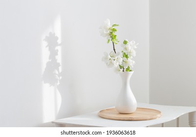 White Spring Flowers In Vase On Vintage Shelf