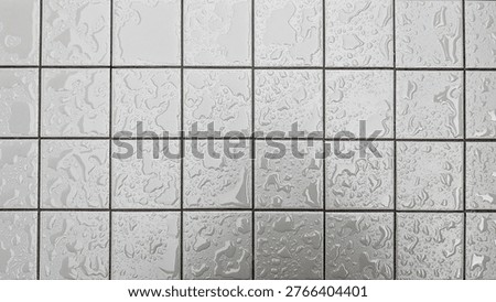 White square ceramic tiles present many water drops, forming a wet, glossy, and textured surface ideal for backgrounds or demonstrating moisture, cleanliness, and freshness