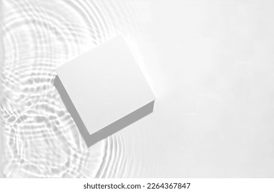 White square podium on the water surface background. Flat lay, copy space.	 Stock Photo