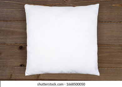 White Square Throw Pillow Mockup On A Rustic Brown Wood Background.