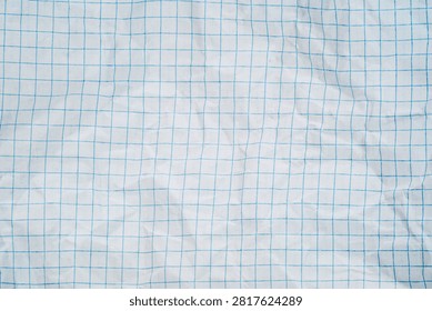 White squared paper texture with blue grid pattern and wrinkled folded surface backdrop