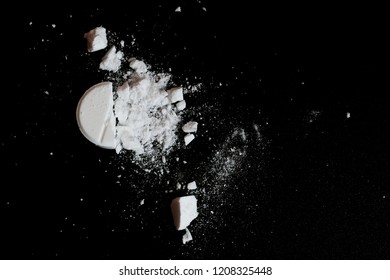 White Squashed Tablet Pill On Black Background