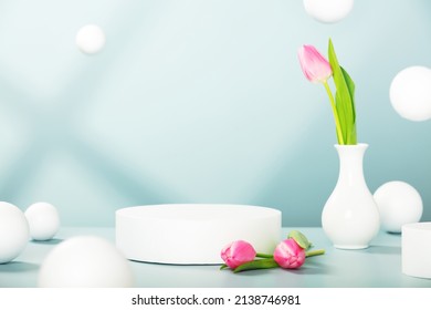 White stage mockup for presentation cosmetic product, advertising, design with single cylinder podium, beautiful tulips and flying sphere balls. Pastel minimal scene for products promotion display.