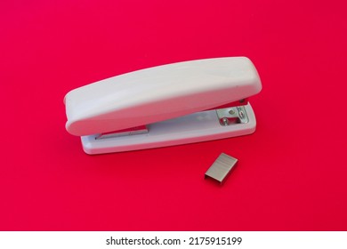 White Stapler Isolated On Magenta Background