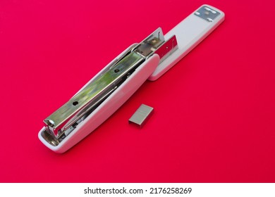 White Stapler Isolated On Magenta Background