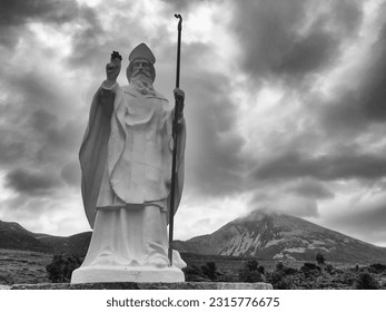 White statue of Saint Patrick at the start of foot path to the peak of Croagh Patrick, county Mayo, Ireland