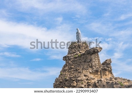 White statue of the Virgin Mary on the Rocher de la Vierge rock in Biarritz
