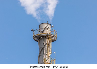 White Steam Or Smoke Billowing From An Industrial Smoke Stack